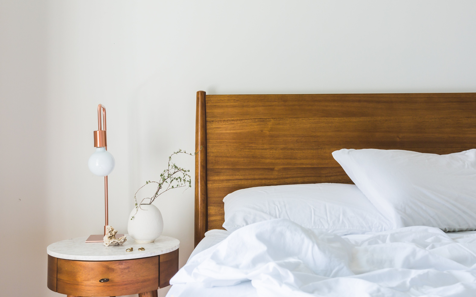 an image of a bed and bedstand